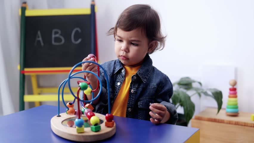 Latin kid playing with didactic toys at preschool or daycare room. Education culture concept - Powered by Shutterstock - Get 15% off with code: PIKWIZARD15