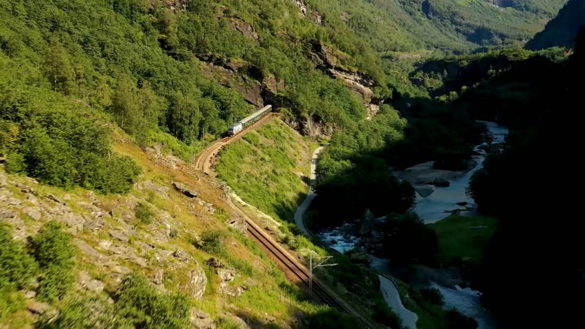 Scenic Train Journey Through Mountain Valley Landscape