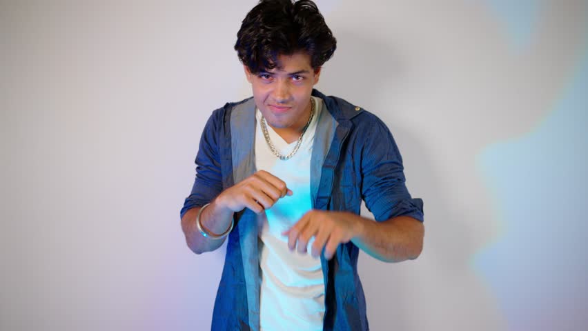 Cool Model Posing for a Stylish PhotoShoot, Male dancer smiling postures in an ad campaign shoot, Guy showcases fresh urban flair, Person performing glam expressions during portfolio, Man with style