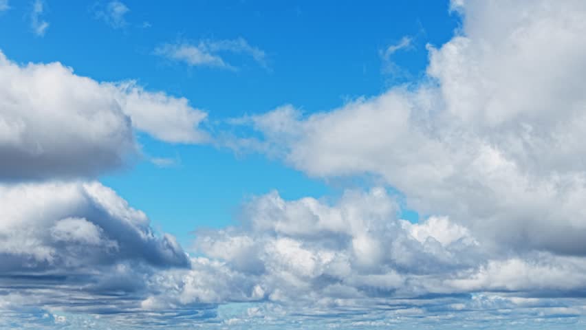 Clear sky with fluffy clouds drifting, a serene atmosphere over the horizon