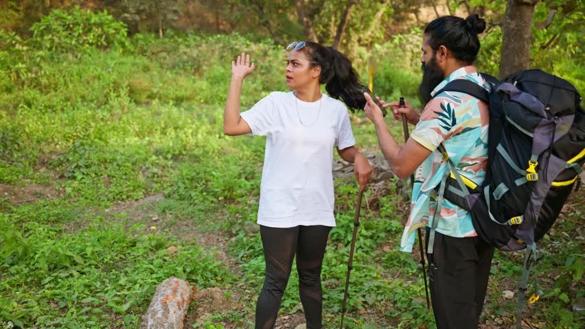 Two hikers shake hands as buyer clicks land photo outdoors, Deal final between lady owner and bearded tourist, Traveler backpacker take picture of farmland, Trekkers cross green fields with gear, Trek