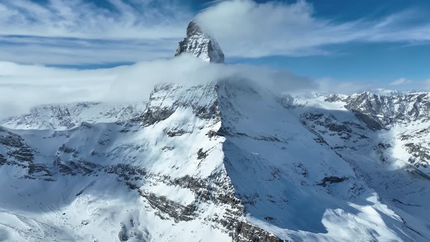 Aerial drone fly around Matterhorn Glacier Paradise during winter in Switzerland. Majestic mountain peaks iconic famous Zermatt travel ski resort in the alps. Wonderful inspiring nature landscape