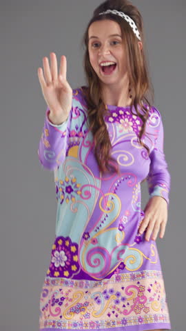 Dancer, groovy and fashion with face of woman in studio for retro style, funky vibe and bohemian culture. Paisley dress, indie aesthetic and disco music with person on gray background for energy
