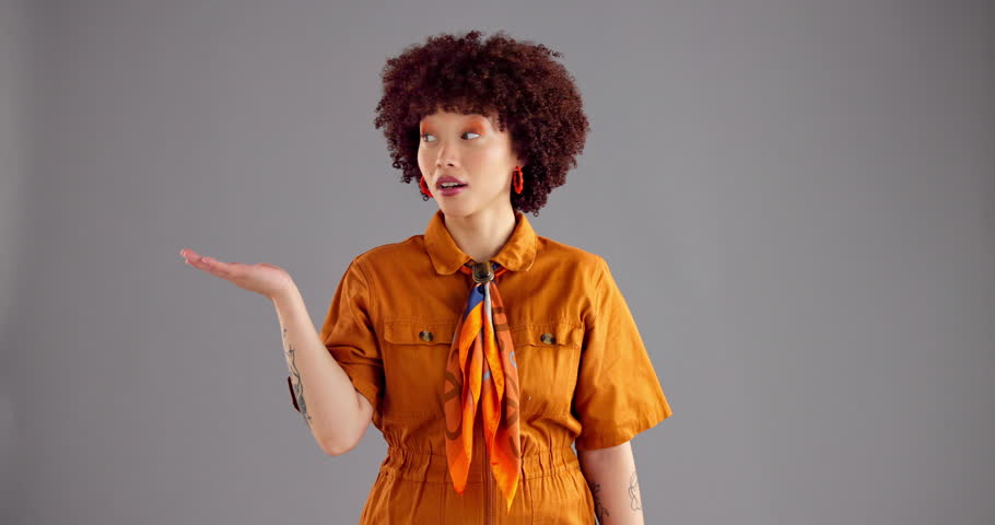 Happy woman, face or hands out with option in studio for choice, pick or selection on a gray background. Portrait, female person or model with smile, palms or decision for advertising on mockup space