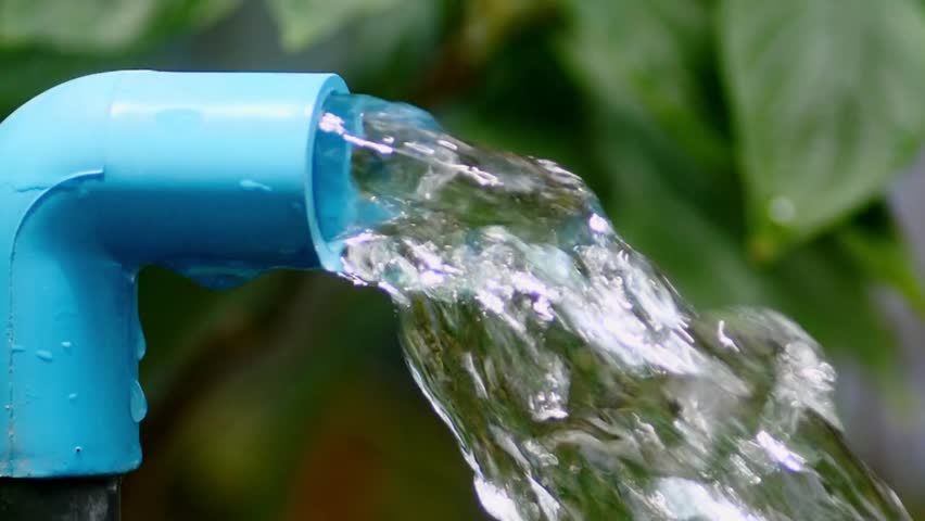 Flowing Water from Blue Pipe: A close-up shot of pure, clear water cascading powerfully from a bright blue pipe, symbolizing resource conservation and freshness.