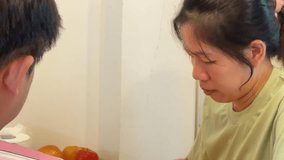 The East Asian couple is playing a game of draughts in the living room. - Powered by Shutterstock - Get 15% off with code: PIKWIZARD15