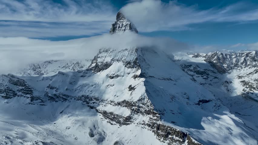 Aerial drone fly around Matterhorn Glacier Paradise during winter in Switzerland. Majestic mountain peaks iconic famous Zermatt travel ski resort in the alps. Wonderful inspiring nature landscape