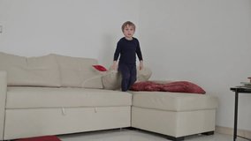Child playing and jumping on sofa with red star shaped toys - Powered by Shutterstock - Get 15% off with code: PIKWIZARD15