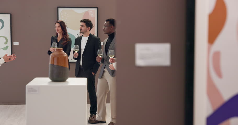 Man, presentation and exhibition with art at gallery with wine glass, explain and smile for deal. People, curator and customer group with sculpture, happy and event for audience for talk with sale