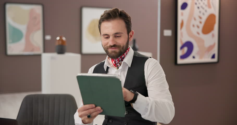Tablet, man and creative curator in art gallery for scroll, review or social media post for exhibition promotion. Tech, happy worker and update digital catalog, schedule and check email in museum