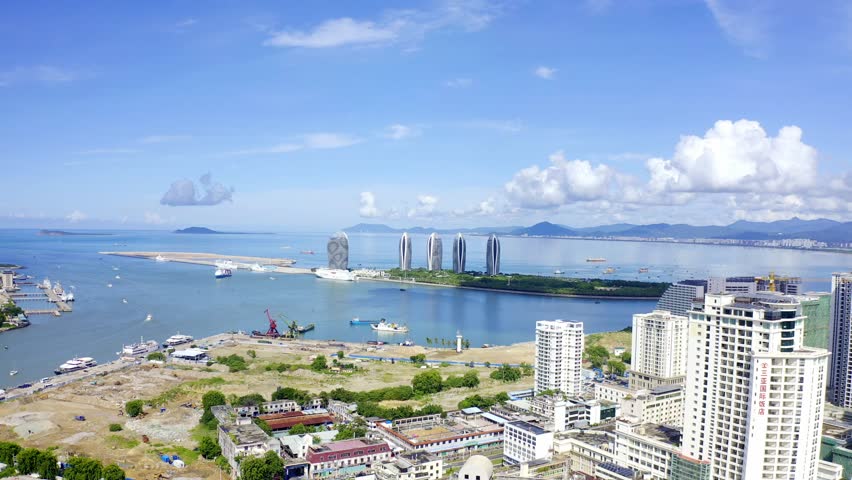 Explore stunning aerial views of Sanya Phoenix Island with clear skies