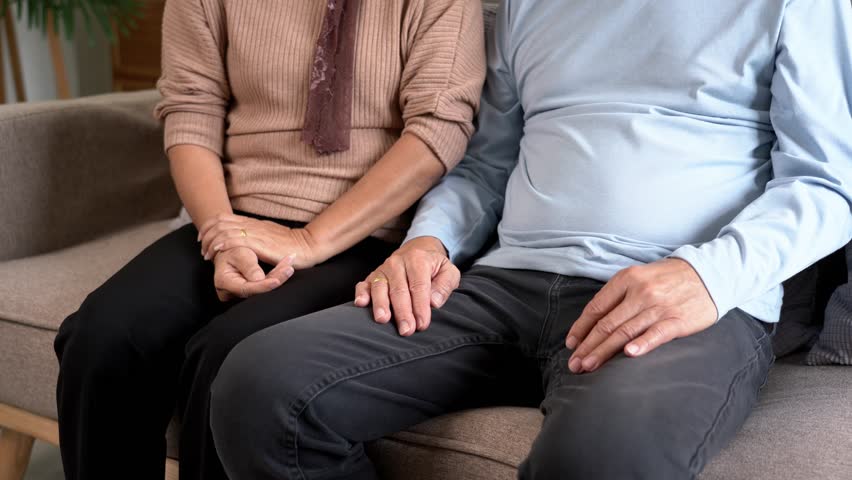 Video 4K Resolution of Senior caregiver touching hands to give support and trust encourage elderly patient