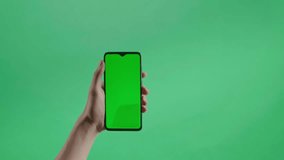 Hand tap touch green screen smartphone on the green screen background - Powered by Shutterstock - Get 15% off with code: PIKWIZARD15