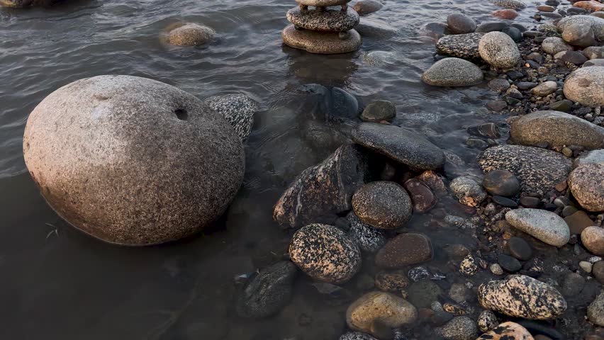 Balance river stone tower in a flowing river water.