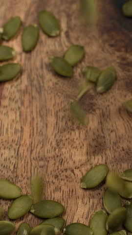 Raw Peeled Pumpkin seeds Falling down on heap, close up