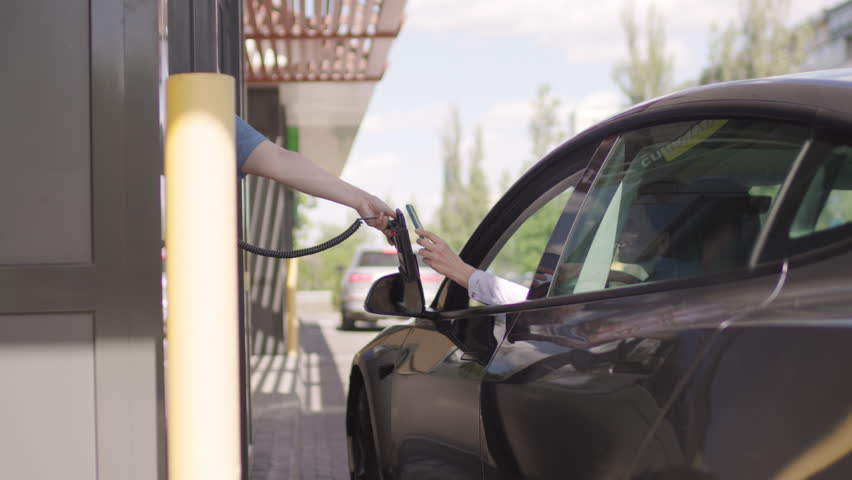 Woman Making NFC Payment from Car. Contactless Transaction