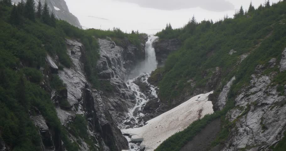 Waterfall as viewed from the Endicott Arm fjord, Alaska, in a misty morning.