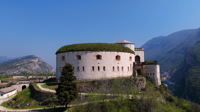 Aerial orbit view of the historic Forte di Rivoli, Italy. Showcasing its unique architecture and mountainous backdrop