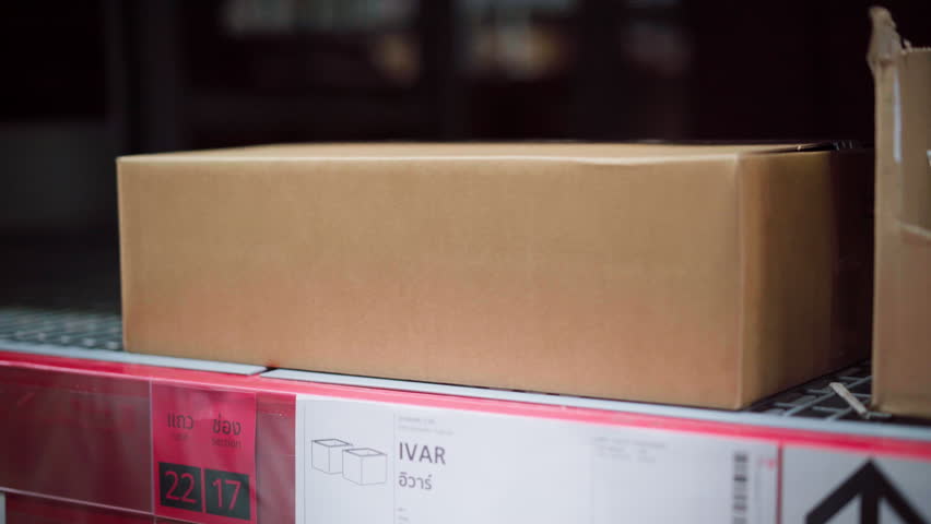 Close Up of Hand Handling Cardboard Box for Delivery and Packaging in Logistics and Shipping Storage Process