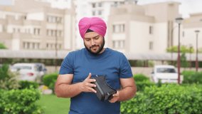 Sikh Indian Man looking at VR Headset, Virtual Reality Headset - Powered by Shutterstock - Get 15% off with code: PIKWIZARD15