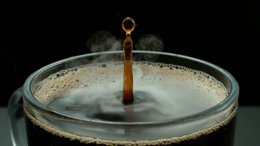4K slow motion video of a coffee drop falling onto another splash, creating a dramatic liquid impact. Perfect for beverage, food, coffee and drink-related content.
