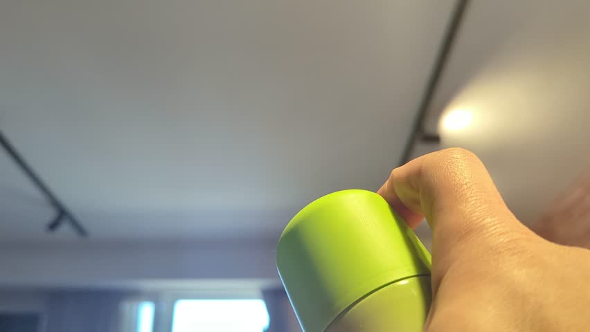 Freshening up the air with a spray can in the living room
