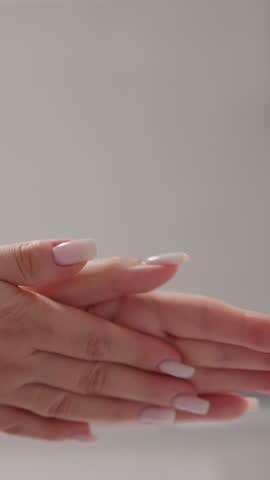 Lady rubs nourishing cream with anti-aging effect on hands skin slow motion. Woman smears hands with nourishing product to improve quality of skin