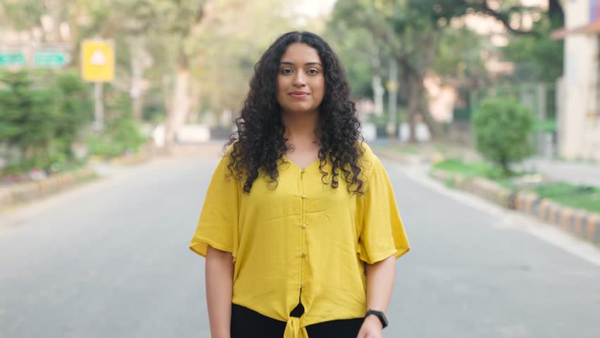 Curly Hair Indian Girl Standing with Trending Poster