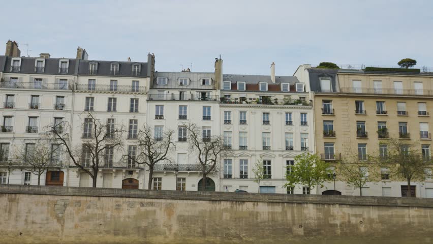 Riverboat cruise on the Seine. View of the old elegant mansions on the Quai d'Orleans on the island de Cite in the 4th arrondissement in Paris, France.