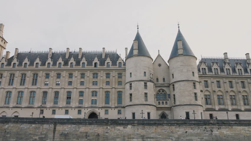 View of the majestic medieval Conciergerie Palace, a former courthouse and prison in Paris, France, located on the western side of the Island Cite (Ile de la Cite) beneath the Palais de Justice.