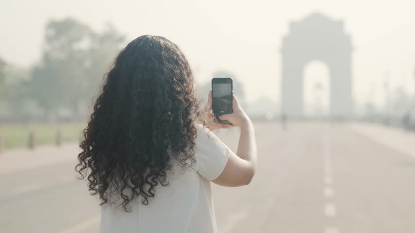 Indian Girl with Curly Hair Clicking Pictures of India Gate