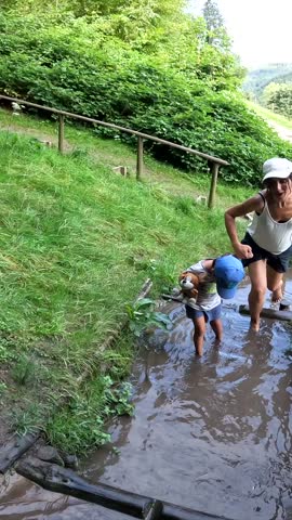 Walking barefoot through mud and water in a sensory park to enjoy nature and the senses, Black Forest, Germany