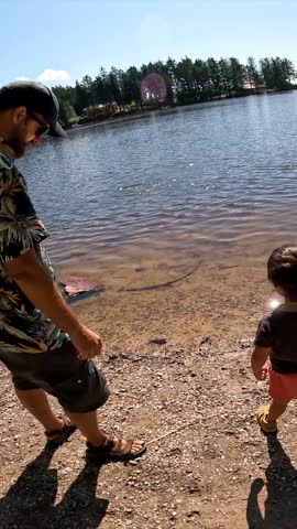 Father and son playing at Mummelsee, Black Forest, Germany