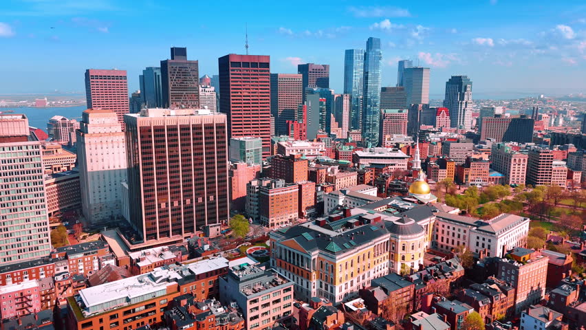 Varied scenery of modern downtown in Boston, Massachusetts, USA. Distancing from the group of skyscrapers flying over the low-rise buildings.