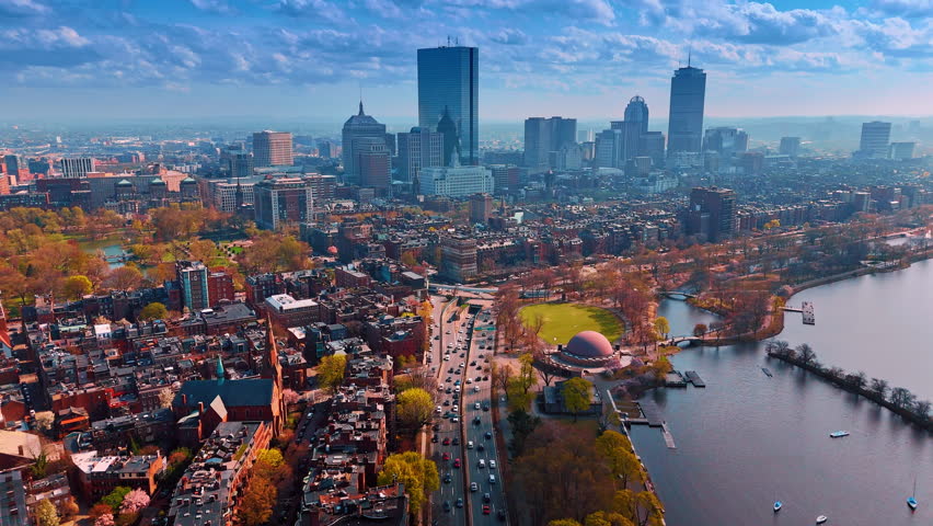 Footage above the busy road along the bright cityscape of Boston in autumn. Beautiful panorama of the city under the cloudy sky.