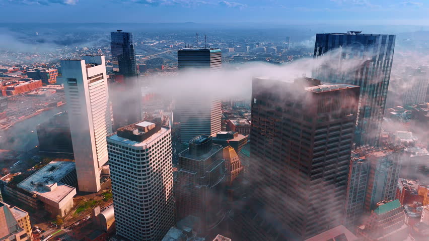 White smoke rises over the tower tops. Aerial perspective on Boston, Massachusetts, USA covered with smoke. Air pollution in metropolis.