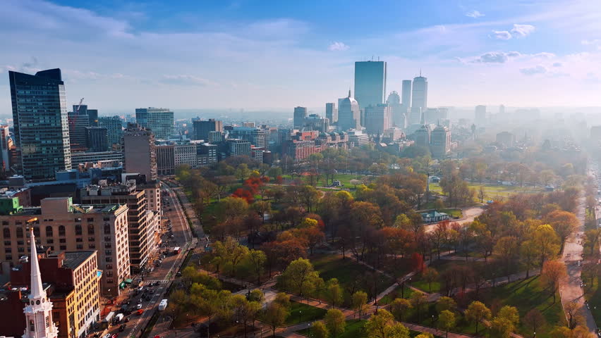 Colorful trees in the park of Boston, Massachusetts, USA. Downtown of the metropolis is covered with smoke. Aerial view.
