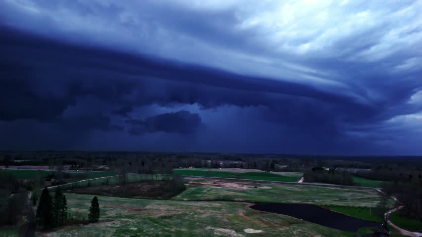 Storm clouds dark blue gray skyline rural field forest aerial landscape bad weather