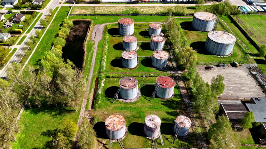 Old rusty crude oil refinery factory production plant gas storage, aerial drone