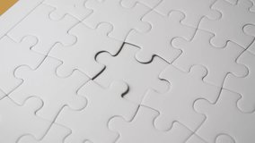 A child's hand placing a puzzle piece, symbolizing the concept of autism in children - Powered by Shutterstock - Get 15% off with code: PIKWIZARD15