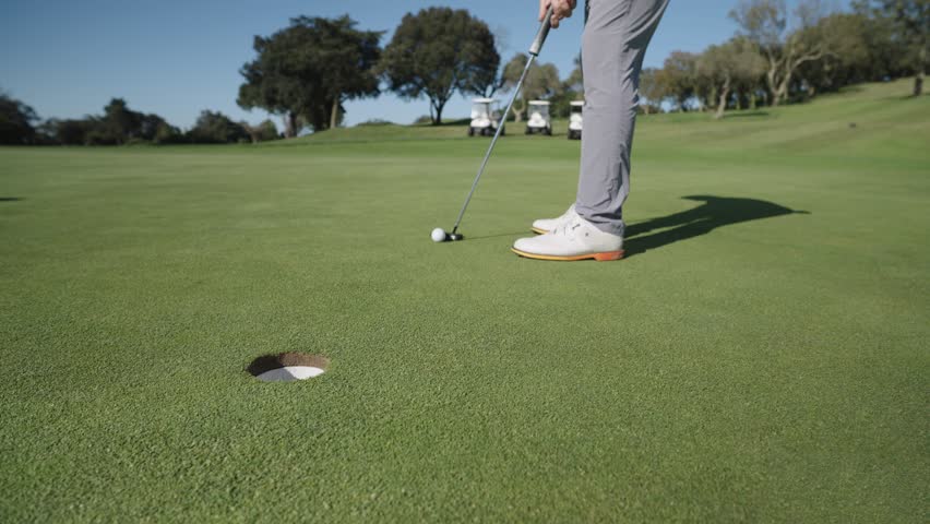 Golfer putting ball on green in six sequential shots
