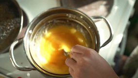 Slow-motion video of honey and butter melting together in a glass bowl over a steam bath for pie filling preparation - Powered by Shutterstock - Get 15% off with code: PIKWIZARD15