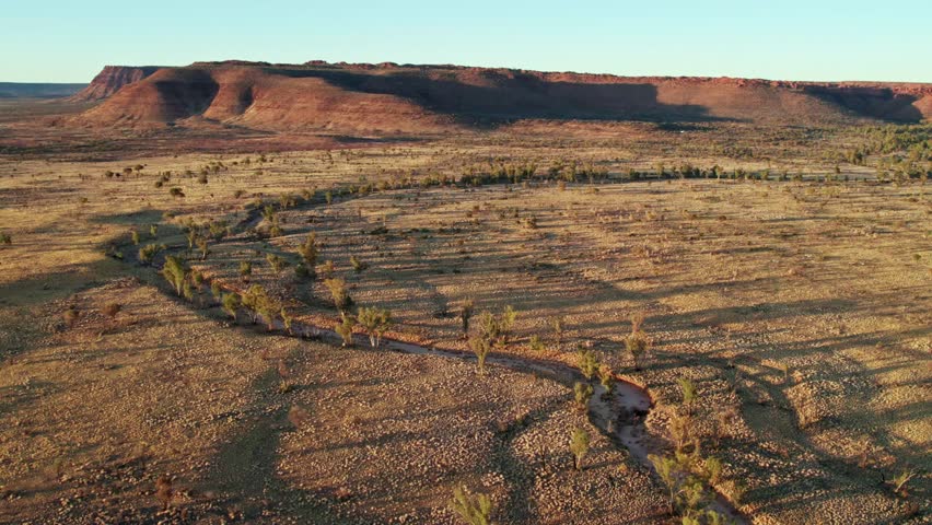 Aerial footage of a small creek and Kings Canyon, Watarrka. Northern Territory, Australia. August 2022