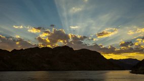 Dramatic Sunset Crepuscular Rays over Mountain Silhouette and Lake - Powered by Shutterstock - Get 15% off with code: PIKWIZARD15