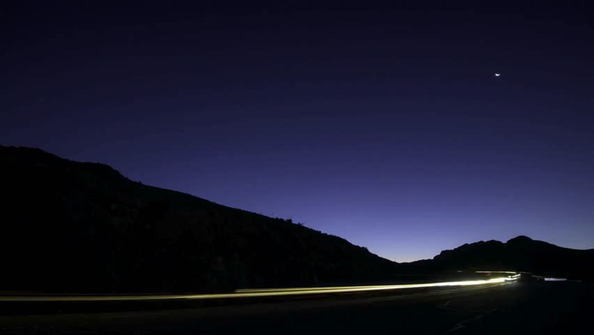 Night Landscape: Dark Mountains, Highway Light Trails, Starry Sky