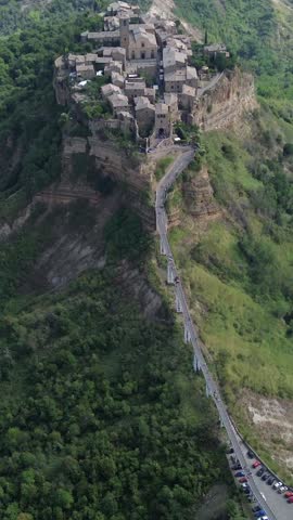 Stunning aerial view of the ancient town of Civita di Bagnoregio, with its unique landscape and surrounding hills in central Italy.