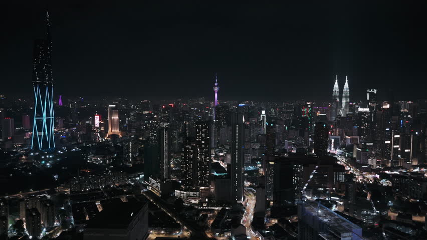 Kuala lumpur cityscape displaying illuminated skyscrapers and bustling streets at night