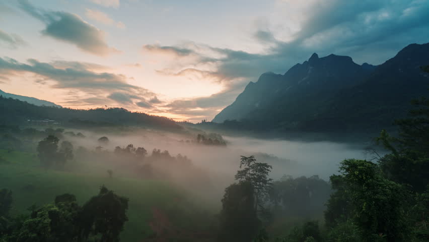 Timelapse landscape of Doi Luang Chiang Dao limestone mountain with foggy flowing over local tribe village among tropical rainforest in the morning at Ban Na Lao Mai, Chiang Dao, Chiang Mai, Thailand