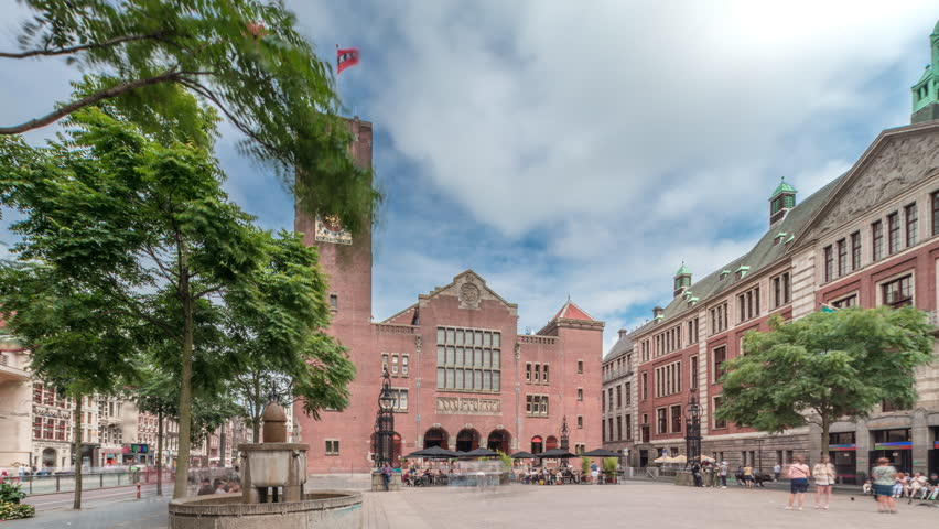 Hyperlapse of Beursplein with the historic Beurs van Berlage building, a former commodity exchange, now a venue for concerts and exhibitions. People walking across the square. Amsterdam, Netherlands
