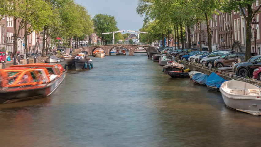 Timelapse panorama of a busy canal boat trip in Amsterdam